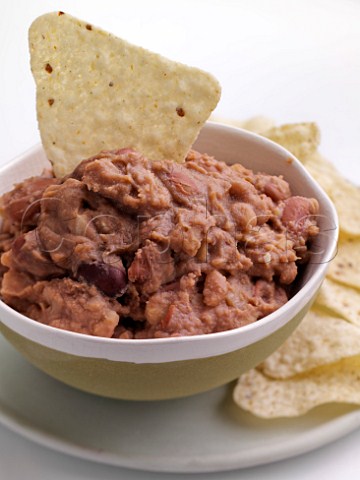 Bowl of refried beans with tacos