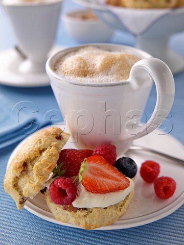 Scones with fresh fruit cream and cappuccino