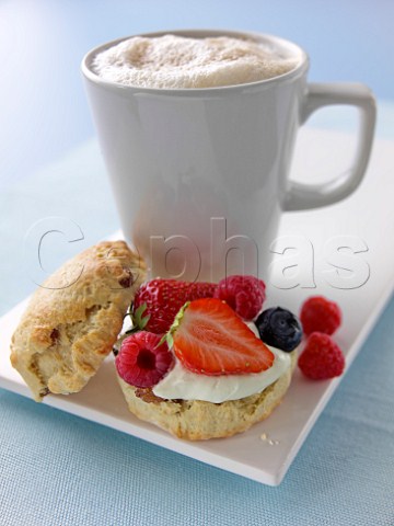 Scones with fresh fruit cream and cappuccino