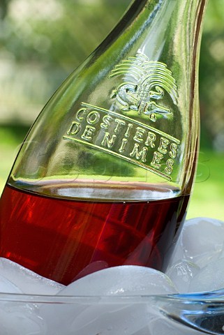 Closeup on bottle of Costires de Nmes ros wine in an ice bucket
