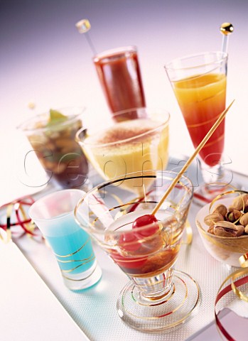 Tray full of colourful cocktails