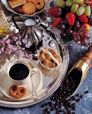 Silver tray with black coffee biscuits and fruit