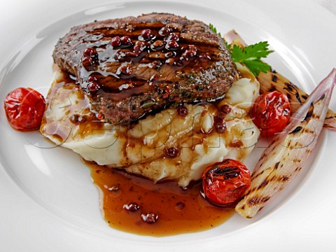 Peppered rump steak on a bed of mashed potato