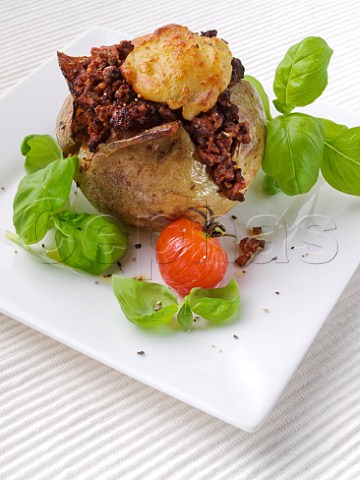 Quorn stuffed jacket potato with grilled cheese topping and tomato