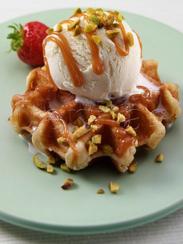 Scoop of vanilla icecream and toffee sauce on a waffle