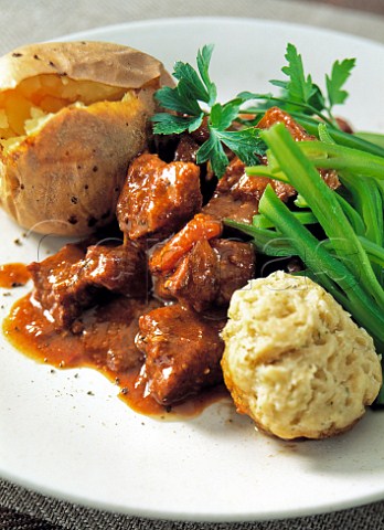 Beef stew with jacket potato green beans and dumpling