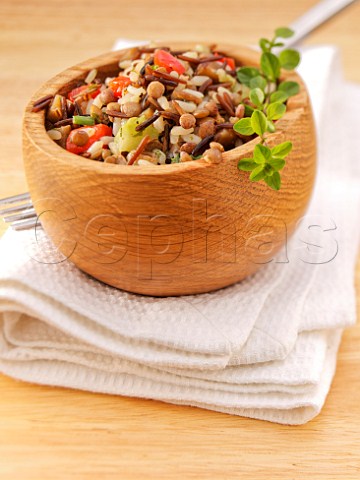 Wild rice and lentil salad with thyme In a wooden bowl