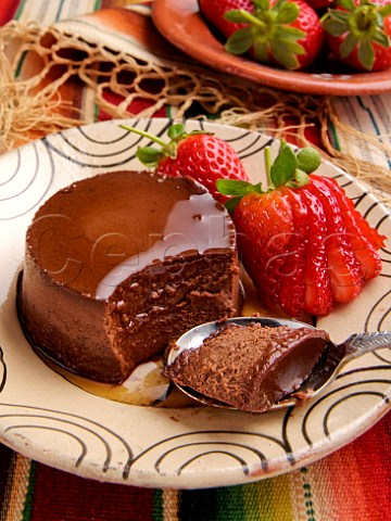 Plate of Mexican chocolate crme caramel with fresh strawberries