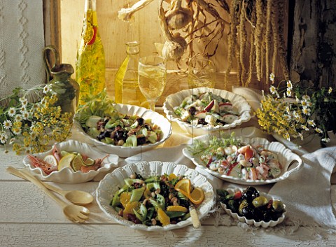 Variety of summer salads buffet style with white wine