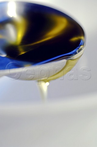 Pouring cooking oil from ladle
