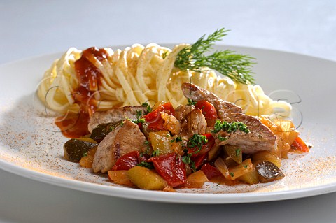 Stirfried pork and vegetables with tagliatelle