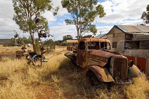 Rusty truck outside preserved miners cottages Gwalia Western Australia