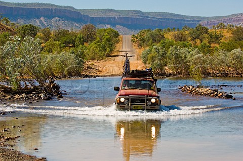 4WD at Pentecost River Crossing on the Gibb RIver Road with Durack mountain range in background Western Australia