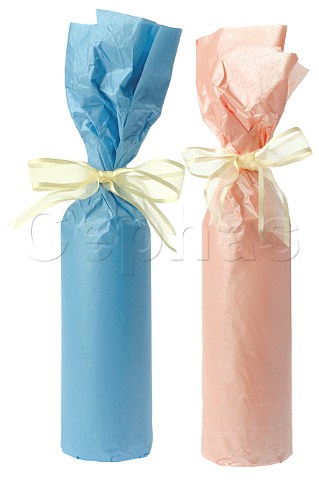 Wine bottles giftwrapped in blue and pink paper