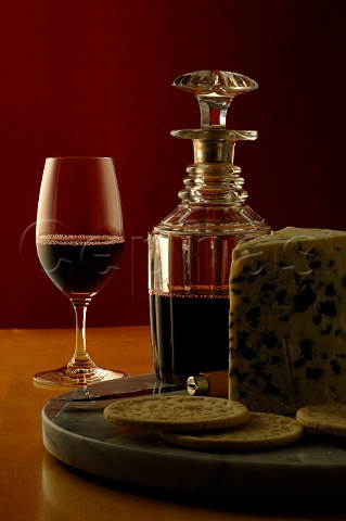 Glass and decanter of port with blue cheese and crackers