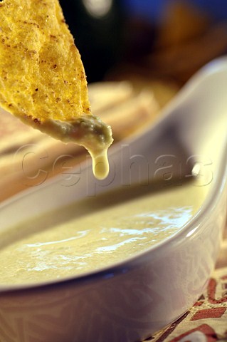 Tortilla chip with cheese sauce dip