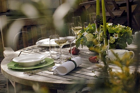 Summer garden table set for three courses
