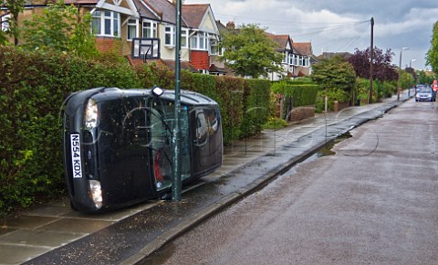 Overturned car on pavement London England