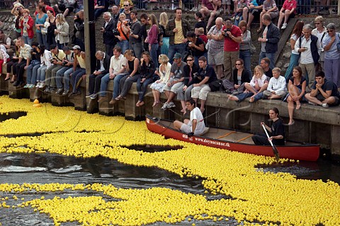 Some of the 165000 plastic ducks start the Great British Duck Race 2007 from Molesey lock and set a new Guinness World Record as spectators line the river bank River Thames near Hampton Court Surrey England
