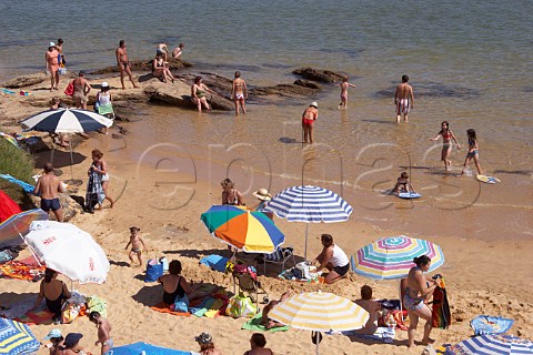 People on the beach by the Mira River estuary at Vila Nova de Milfontes Odemira Portugal