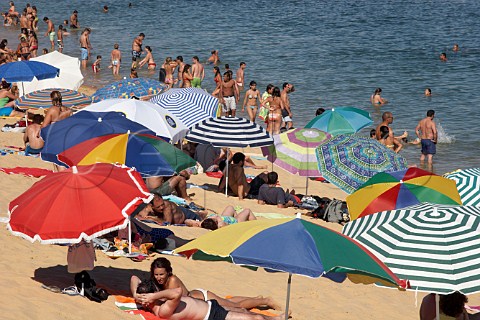People enjoying the beach by the Mira River estuary at Vila Nova de Milfontes Odemira Portugal