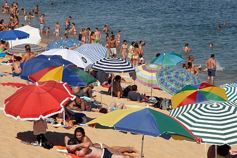 People enjoying the beach by the Mira River estuary at Vila Nova de Milfontes Odemira Portugal