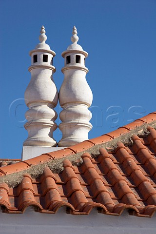Chimneys on traditionally tiled roof at Vila Nova de Milfontes Odemira Portugal