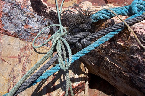 Mooring ropes on harbour rocks Vila Nova de Milfontes Odemira Portugal