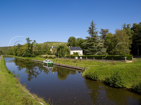 Canal du Nivernais at Vincelles with in distance vineyards on the Col de Crmant above Bailly Yonne France Cte dAuxerre