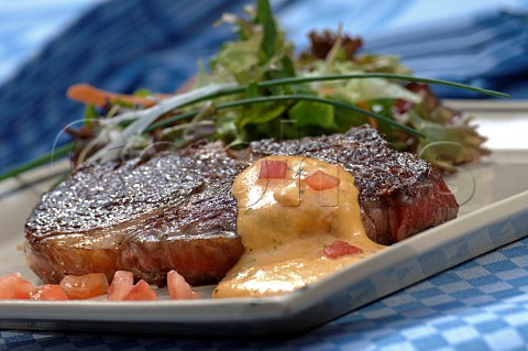 Medium rare steak with salad