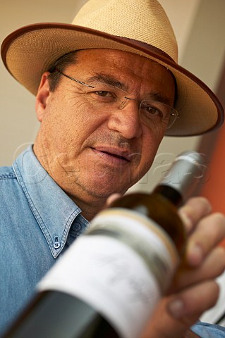 Christos Anagnostou of Anagnostou Winery holding a bottle of retsina Koropi Greece Attica