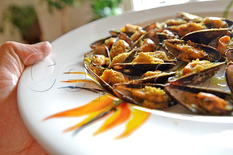 Spanish style grilled mussels in half shells