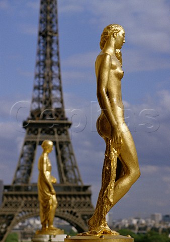 Gilded statues at the Palais de Chaillot in the  Trocadro with the Eiffel Tower beyond   Paris France