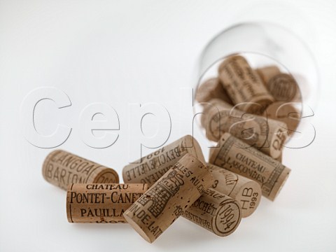 Mdoc Grand Cru Class wine corks spilling from a Riedel Bordeaux wine glass