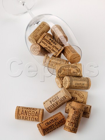 Mdoc Grand Cru Class wine corks spilling from a Riedel Bordeaux wine glass