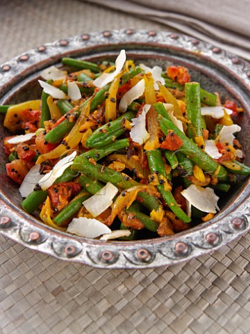 Dish of spicy green bans with coconut