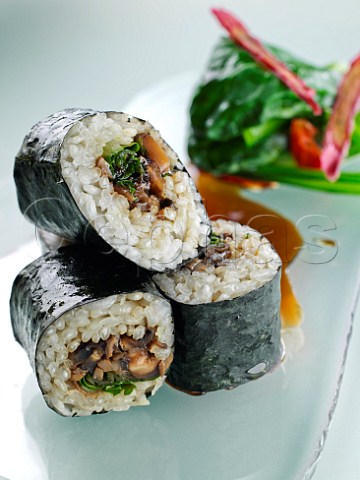 Sushi wild mushroom rice roll with teriyaki sauce and wok seared greens