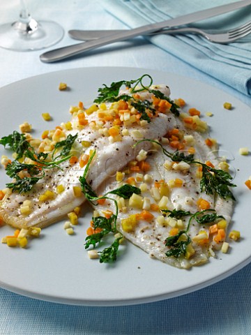 Two lemon sole fillets with diced vegetables