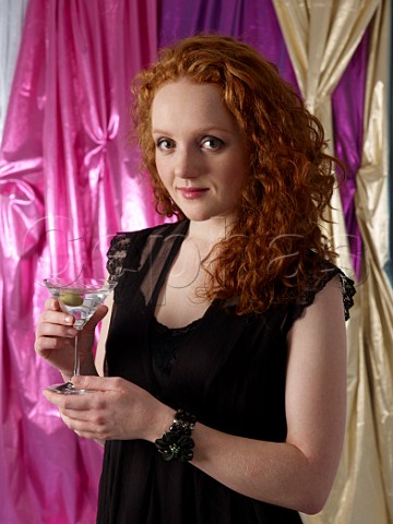 Young woman holding a Martini cocktail
