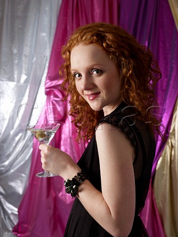 Young woman holding a Martini cocktail