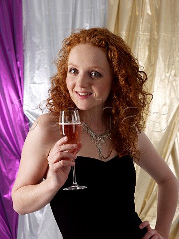 Young woman holding a glass of ros champagne