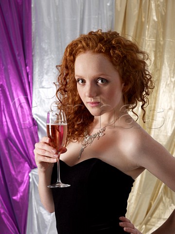 Young woman holding a glass of ros champagne