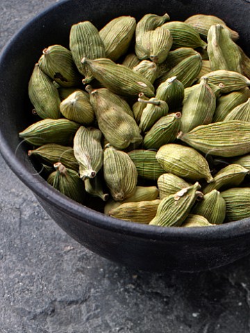 Cardamoms in a wooden bowl
