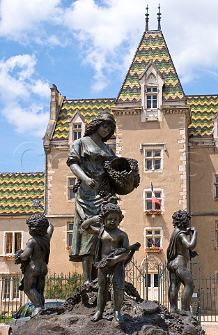 Bronze statue of young woman with cherubs and grapes in front of the town hall in Meursault Cte dOr France Cte de Beaune