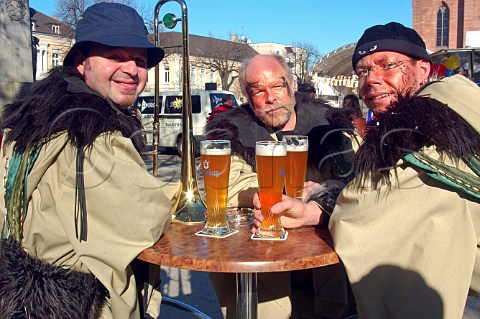 Men drinking beer at carnival in Kehl BadenWrttemberg Germany