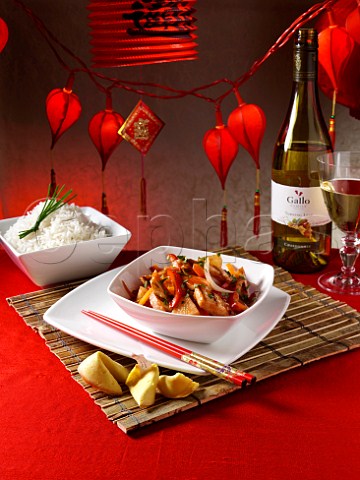 Chinese sweet and sour chicken with rice  Bottle of Gallo Chardonnay