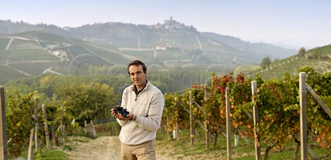 Franco Massolino holding Nebbiolo grapes in his Vigna Rionda vineyard Serralunga dAlba Piemonte Italy Barolo