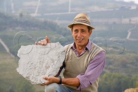 Giovanni Massolino holding a piece of calcareous marl rock typical of the region in vineyard of Massolino Serralunga dAlba Piemonte Italy Barolo