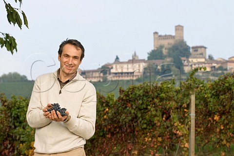 Franco Massolino holding Nebbiolo grapes in his Vigna Rionda vineyard Serralunga dAlba Piemonte Italy Barolo