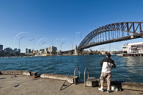 Fisherman at Walsh Bay Sydney with the Harbour Bridge behind New South Wales Australia